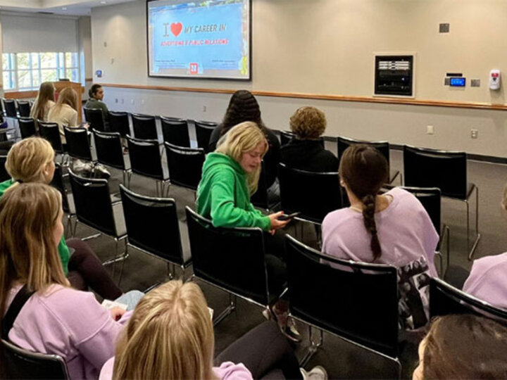 Students sitting watching a presentation