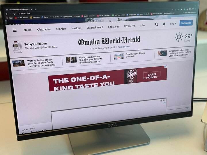 Desktop computer with Omaha-World Herald website pictured