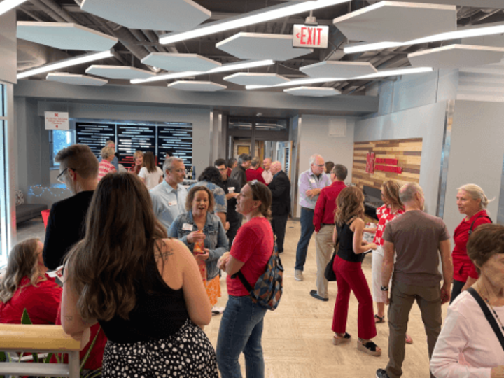 alumni gather in the Andersen Hall lobby during Homecoming party