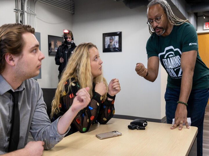 Shoun Hill fist bumping and talking with students