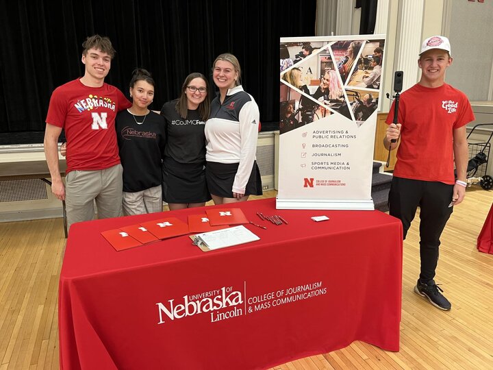 Student ambassadors standing at a booth