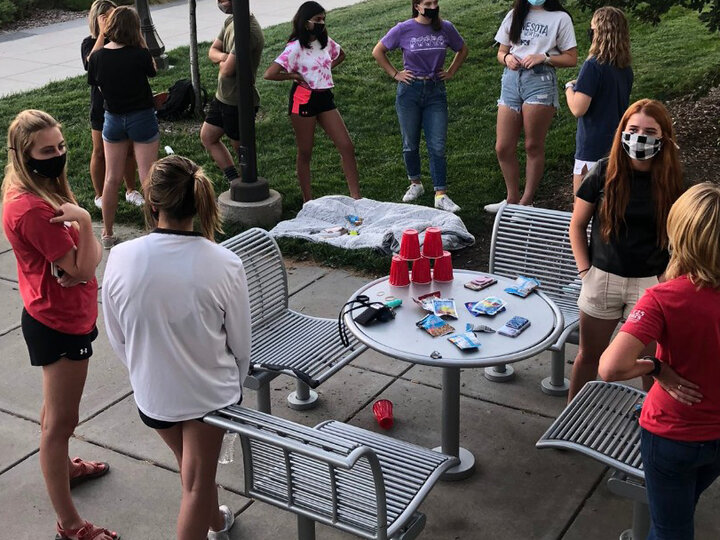 Group of students stand outside while talking 