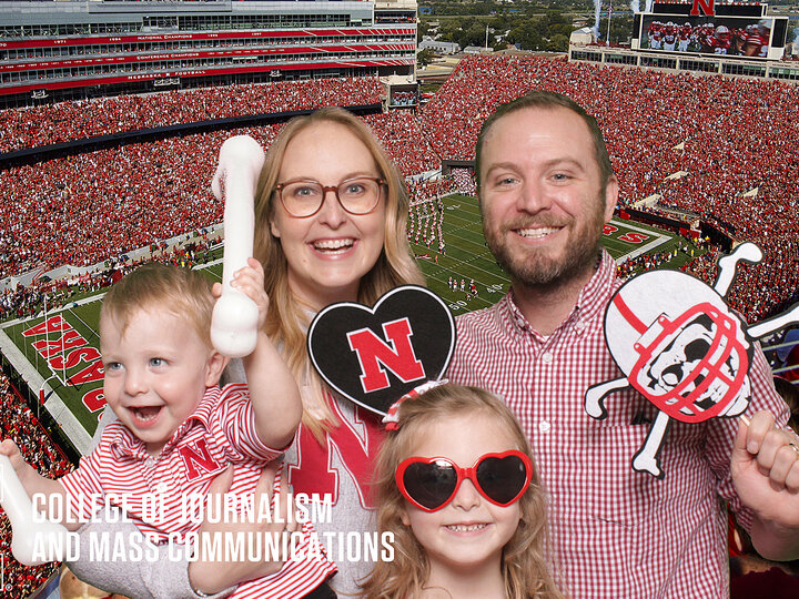 Alumni and their family in front of the football field inside of Memorial Stadium.