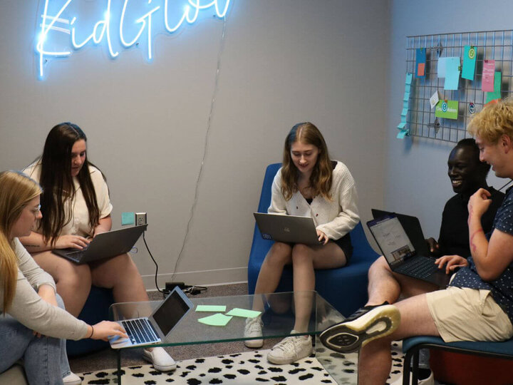 Four students in a group look at computers