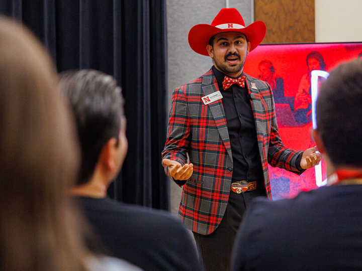 Alex Fernando, assistant director of recruitment for the College of Journalism and Mass Communications, shows his Husker spirit while representing the university. Fernando is featured in the Cornhusker Superfans series highlighting Big Red pride across campus.