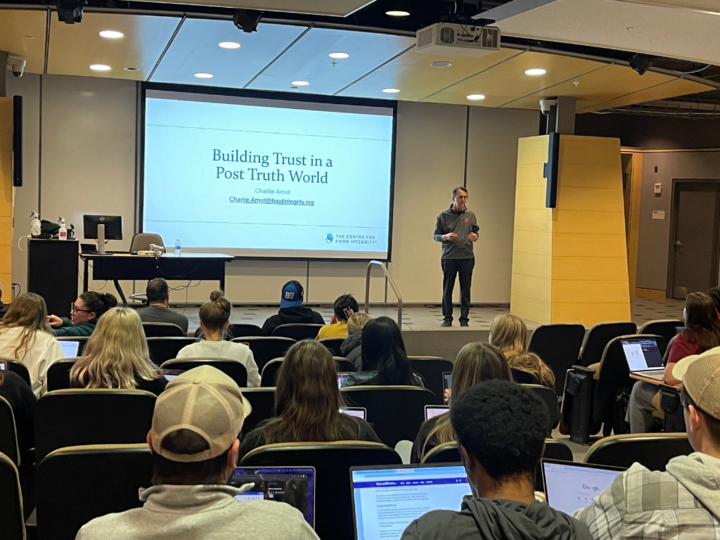 man stands in front of lecture Hall 