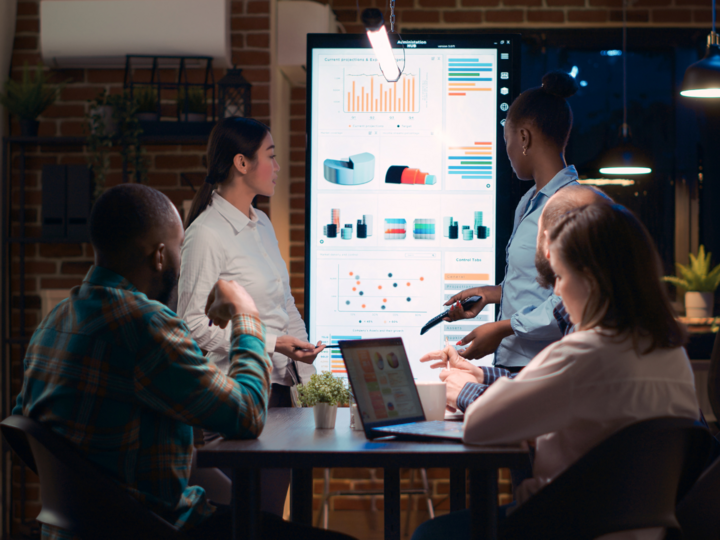 people gathered around a table looking at charts