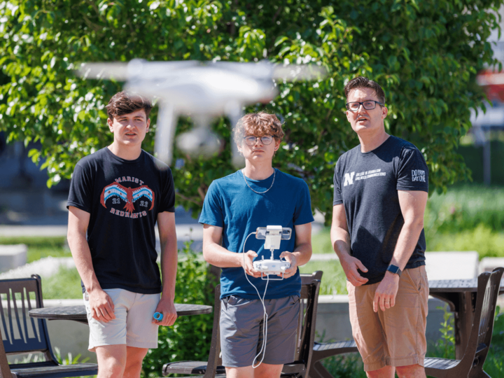 people looking at a drone