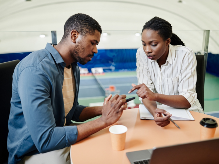 image of two people looking at a phone