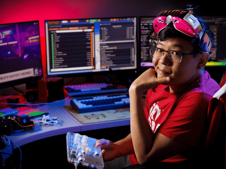 Ryan Tan sits at a desk