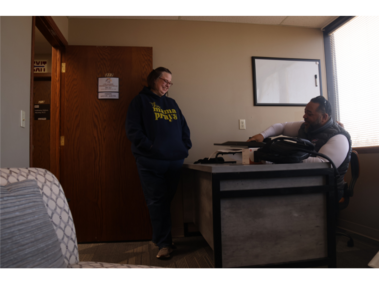 2.	Brandi Hobbs shares a laugh with her husband, Clifton Hobbs, in his new counseling office in Lincoln, Nebraska, on Feb. 21, 2026. Brandi is Clifton’s wife of 26 years and the office manager at both of his counseling locations. “In every part of my life, work and marriage, she is my boss,” Clifton Hobbs said. (Photo by Amanda Yuan)