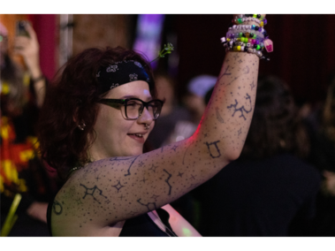 Audience member dances to Callisto and Darkwood’s performance Madelyn Lund, 25, of Omaha, dances in the crowd during Callisto and Darkwood’s DJ set at Duffy’s Tavern on Saturday, Feb. 21, 2026, in Lincoln, Nebraska. Lund traded and gave away Kandi bracelets that she made with others at the set that evening. (Photo by Alex Gryczanowski / UNL College of Journalism and Mass Communications)