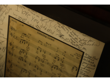 9.	A relic of the past: A framed copy of "Amazing Grace" signed by the congregation hangs in the Glory Tabernacle church on Feb. 21, 2026. The memento reminds Clifton Hobbs of the church's growth. 