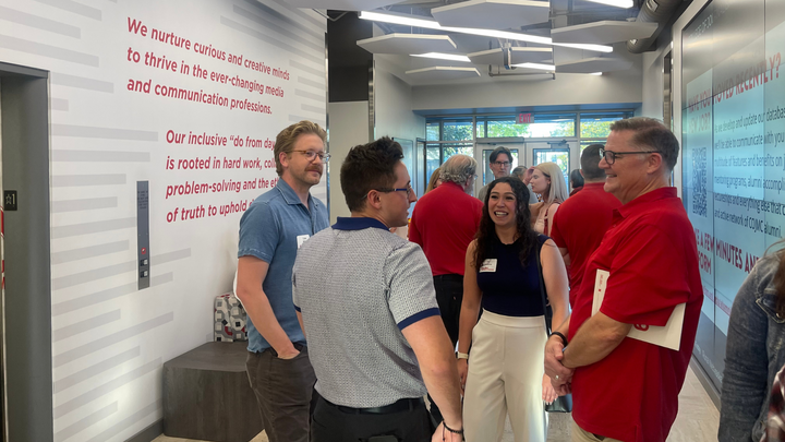 Alums catch up in the Andersen Hall lobby.