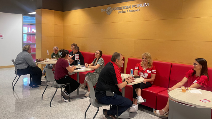 alumni gather in the freedom forum during the homecoming party