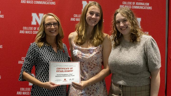 Grace and Chloe Fitzgibbon receive a Certificate of Establishment for the David Fitzgibbon "Fitz" Memorial Scholarship Fund.