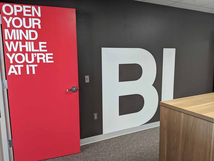 Picture of an office painted in black witha  red door