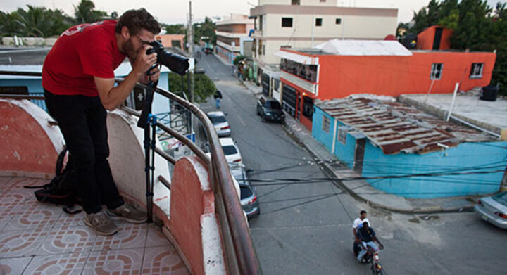 Man takes a photograph while standing on a room in the Dominican Republic