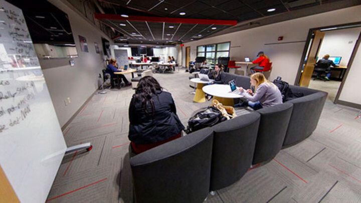stuents sitting on a couch studying