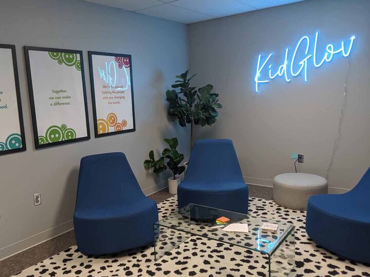 picture of an office with blue chairs and grey wals