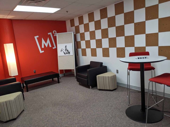 office with one red wall and one checkerboard wal