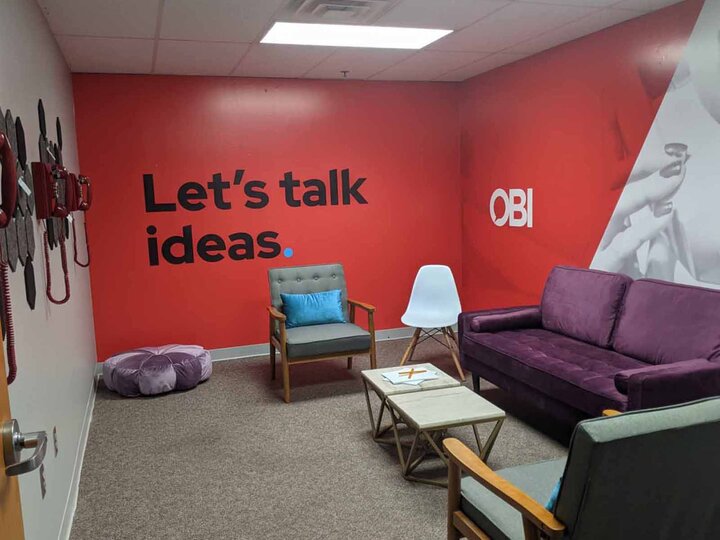 office with red wall and purple counch