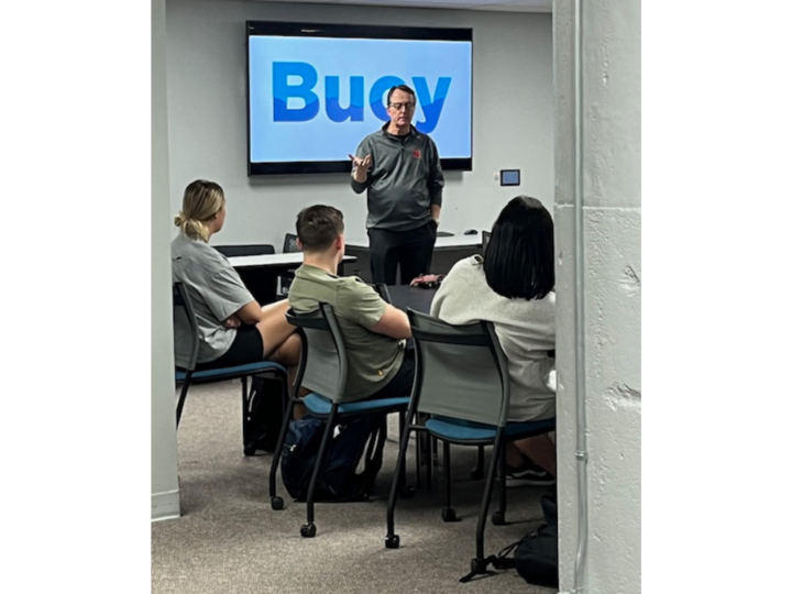 Charlie Arnot leads a roundtable discussion with Buoy Experience Lab students.