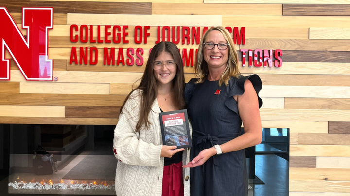 Izzy Lewis (left) accepts the September Student of the Month Award from Dean Shari Veil (right).
