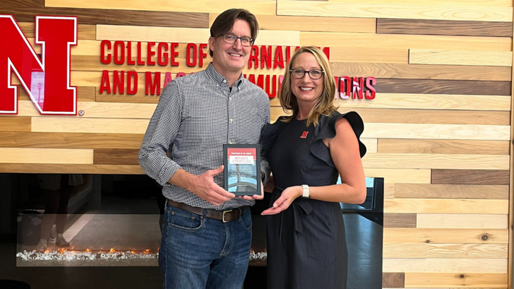 Professor of Practice Matt Waite (left) accepts the September Professor of the Month Award from Dean Shari Veil (right).