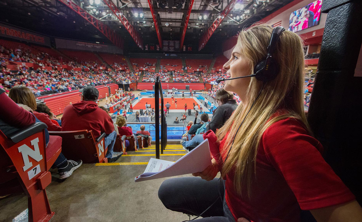 Woman crouches down in a basketballs stadium