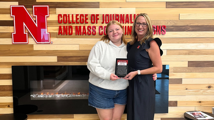 Dean Shari Veil accepts the August Professor of the Month Award from Student Advisory Board President Cady Blackstock.